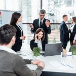 Business people group joining hands and stay as team in circle and representing concept of friendship and teamwork..